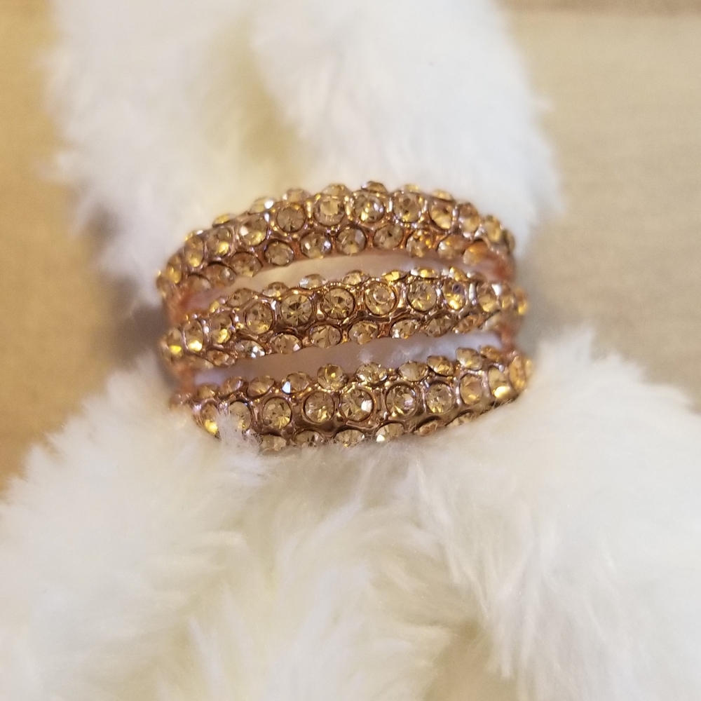 Rose gold colored ring with stones